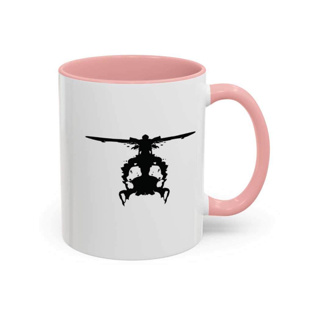 White mug with pink handle and interior, featuring a black inkblot helicopter design on a white background