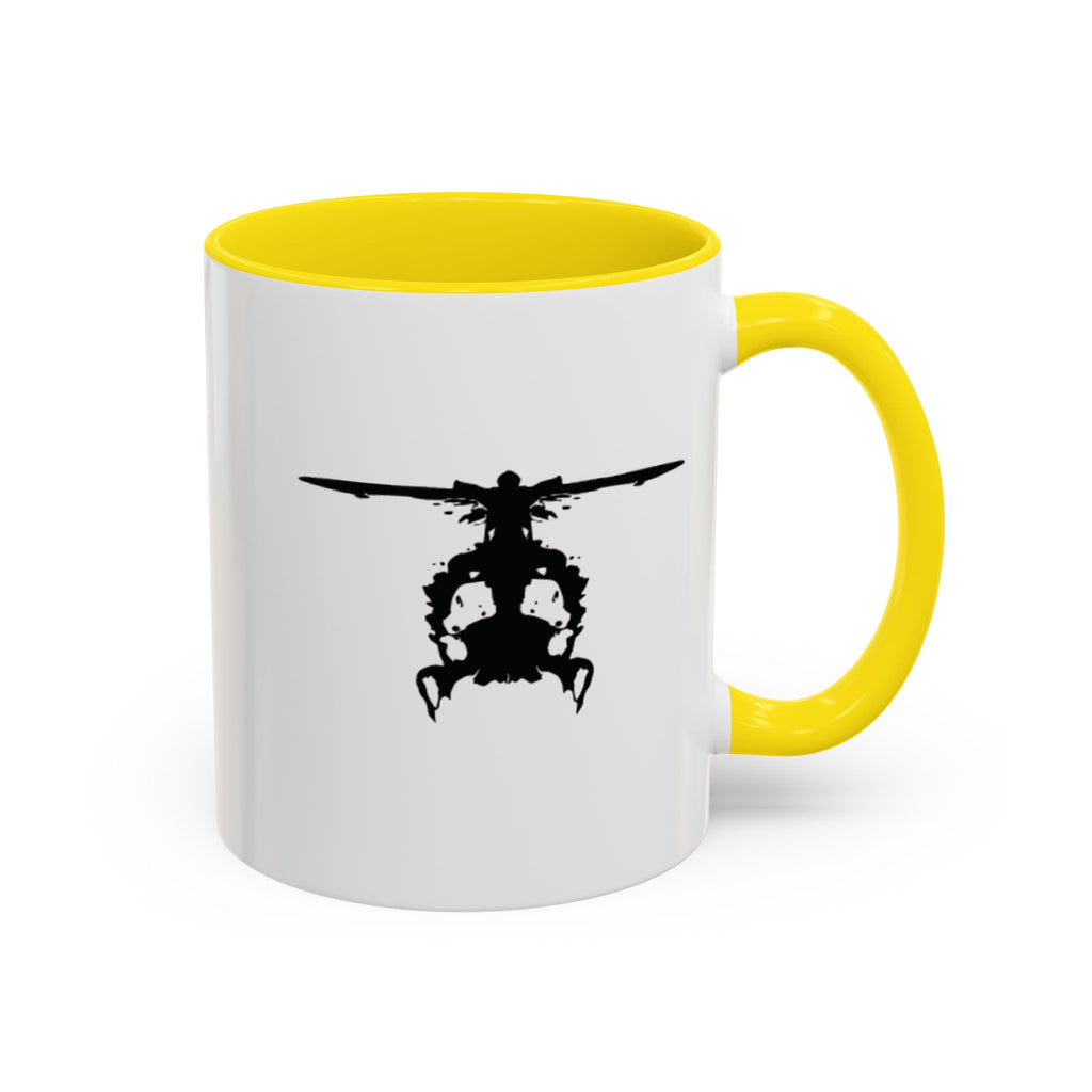 White mug with yellow handle and interior, featuring a black inkblot helicopter design on a white background