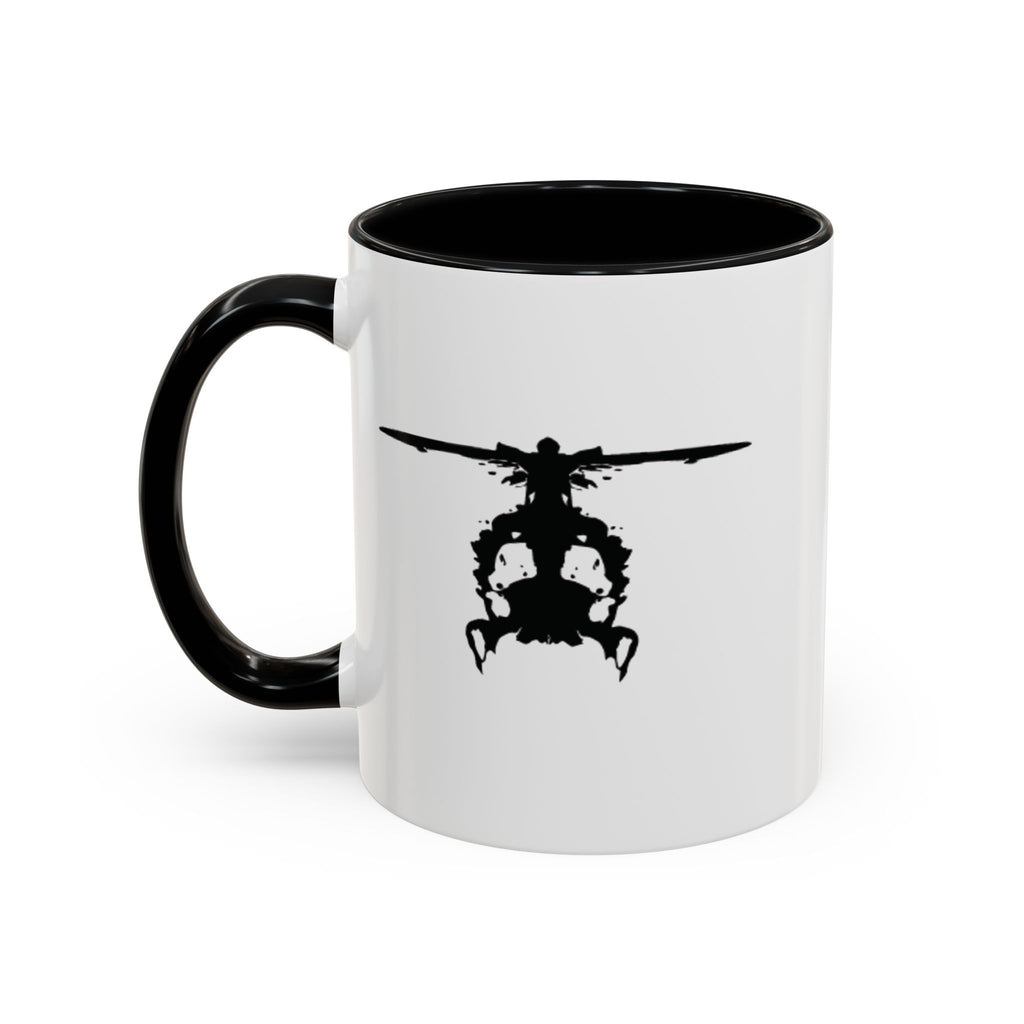 White mug with black handle and interior, featuring a black inkblot helicopter design on a white background