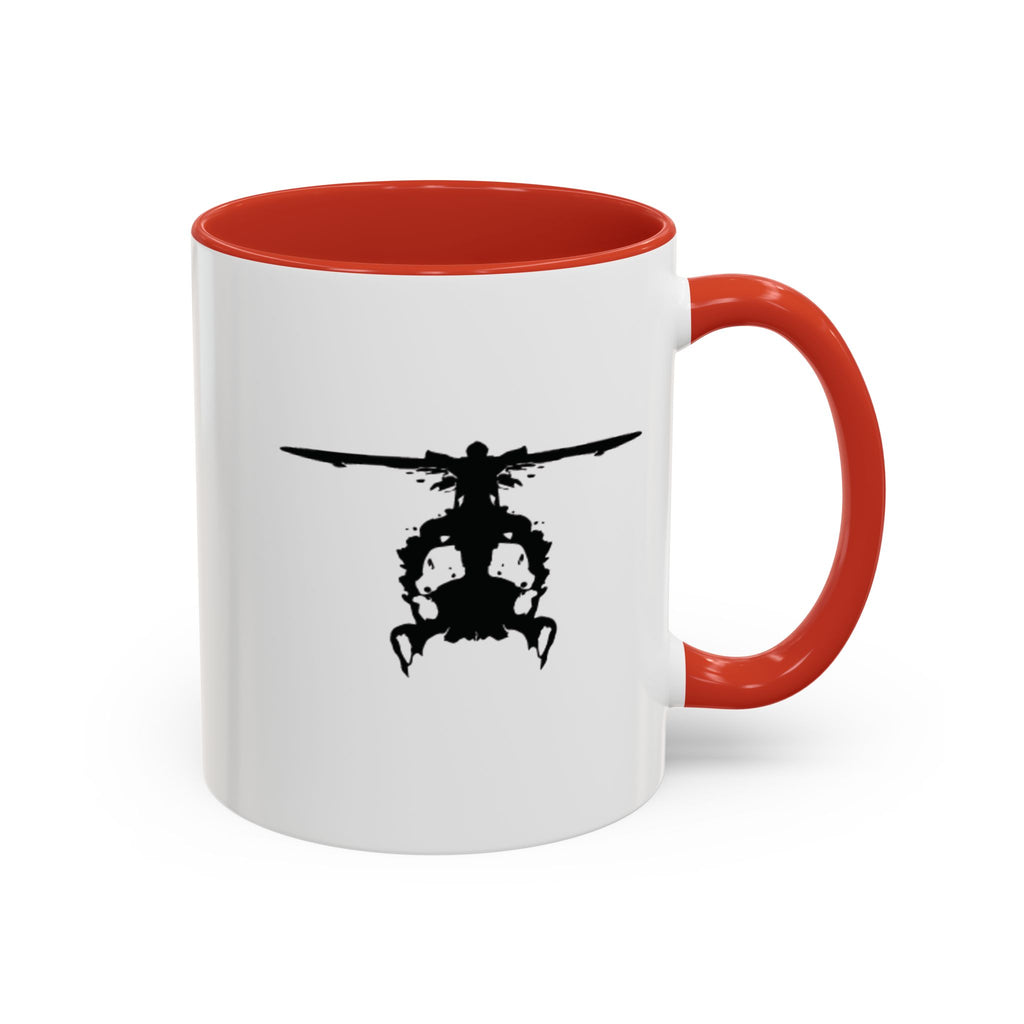 White mug with red handle and interior, featuring a black inkblot helicopter design on a white background