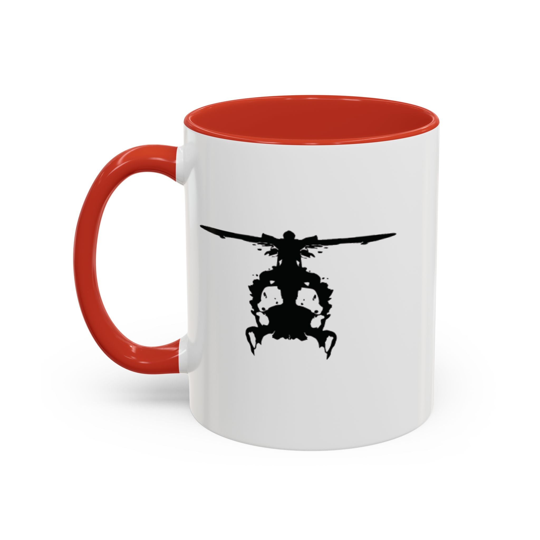 White mug with red handle and interior, featuring a black inkblot helicopter design on a white background