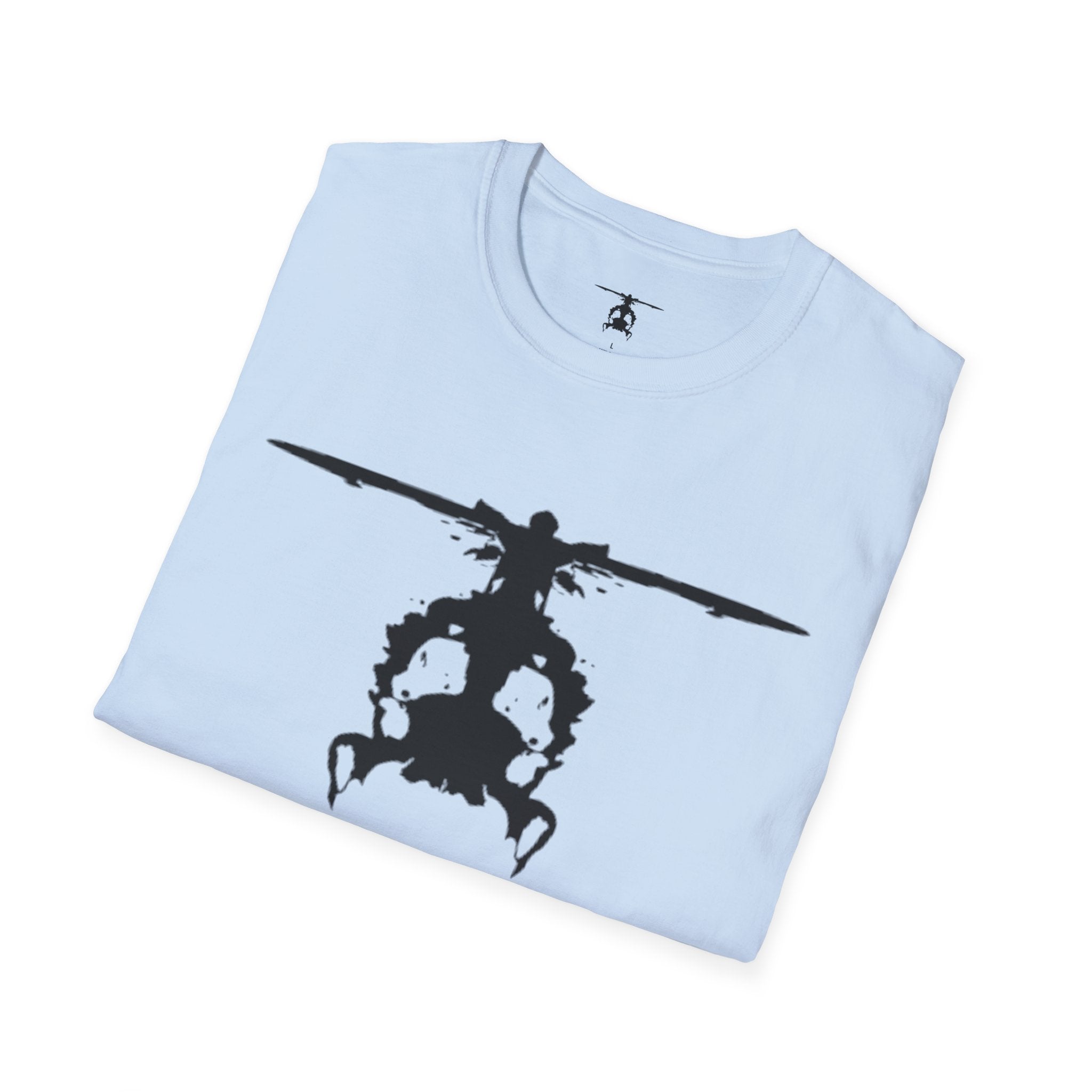Folded light blue T shirt with an inkblot helicopter design on a white background