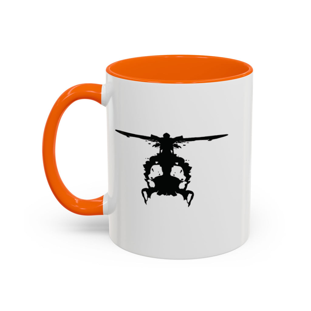 White mug with orange handle and interior, featuring a black inkblot helicopter design on a white background