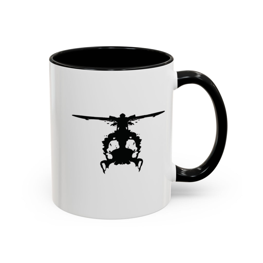 White mug with black handle and interior, featuring a black inkblot helicopter design on a white background