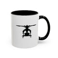 White mug with black handle and interior, featuring a black inkblot helicopter design on a white background