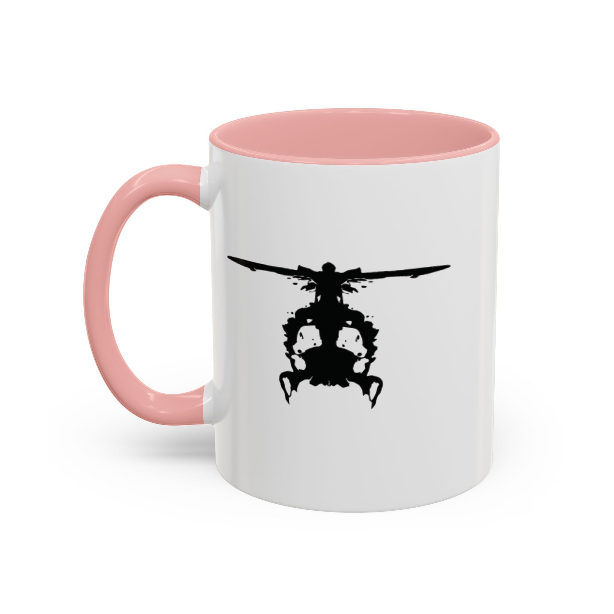 White mug with pink handle and interior, featuring a black inkblot helicopter design on a white background